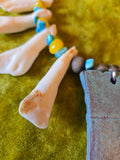 Unforgiven Cow Teeth Tiki Pendant Necklace in teal