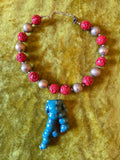 Unforgiven Cinnabar and Teal Coral Tiki Necklace