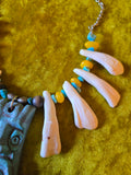 Unforgiven Cow Teeth Tiki Pendant Necklace in teal